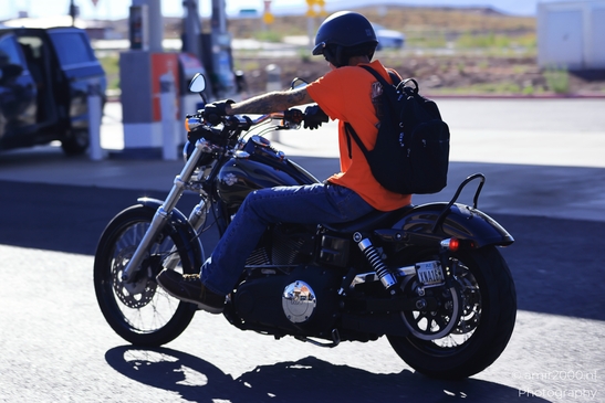 Motorcycle Ride Through Desert in Transportation Collection. A man riding a motorcycle on an - image from year 2025 #005