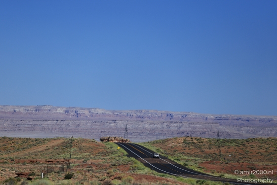 On The Way In Western USA in Transportation Collection. A lone car on a two-lane highway in the - image from year 2025 #033