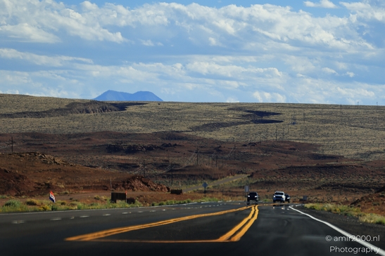 On The Way In Western USA in Transportation Collection. A two-lane highway cuts through a vast - image from year 2025 #035