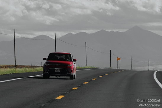 On The Way In Western USA in Transportation Collection. A red truck driving on a desert highway - image from year 2025 #039