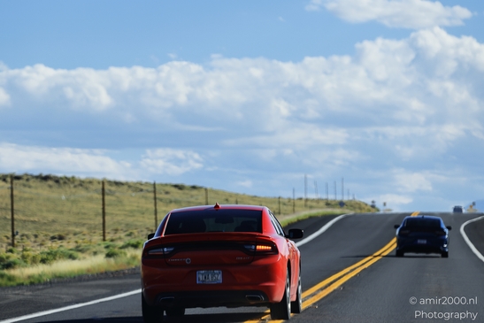 On The Way In Western USA in Transportation Collection. Red Dodge Charger cruising down a sunny - image from year 2025 #042