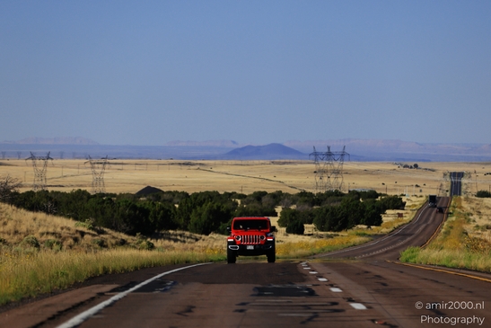 On The Way In Western USA in Transportation Collection. A red truck drives down a two-lane - image from year 2025 #044