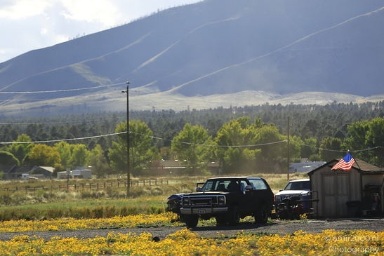 On The Way In Western USA in Transportation Collection. A truck parked in a field with mountains - image from year 2025 #047