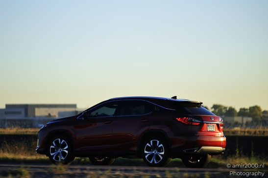 Red SUV driving on road around Denver Colorado Red SUV with license plate and clear road ahead image from year 2025 #1