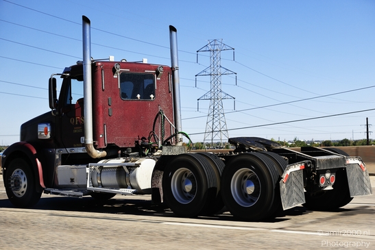 Red semi truck driving on highway Denver Colorado Red semi truck driving down highway with power image from year 2025 #1