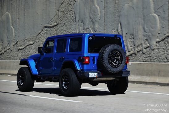 The Highway around Denver Colorado Blue jeep on road with mountain backdrop in Transportation image from year 2025 #4
