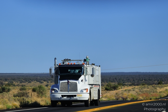 Trucks In Arizona in Transportation Collection. A large utility truck travels down a desert - image from year 2025 #008