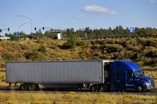 Trucks In Arizona in Transportation Collection. A blue semi-truck driving on a highway in - image from year 2025 #011