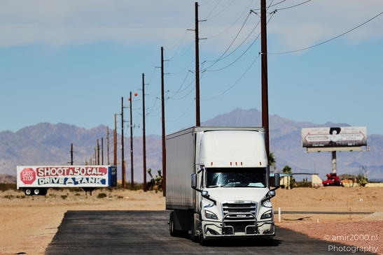 Trucks In Western USA in Transportation Collection. A large semi-truck travels down a desert - image from year 2025 #004