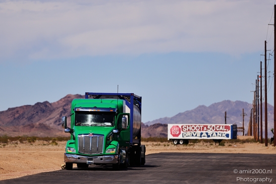 Trucks In Western USA in Transportation Collection. A green semi-truck on a desert highway. - image from year 2025 #007