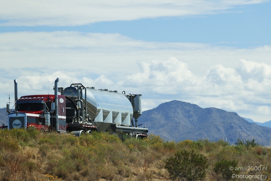 Trucks In Western USA in Transportation Collection. A semi-truck parked on a dirt road under a - image from year 2025 #009