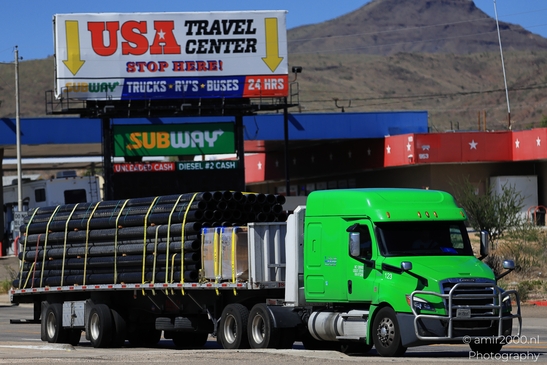Trucks In Western USA in Transportation Collection. A green truck hauling construction materials - image from year 2025 #011