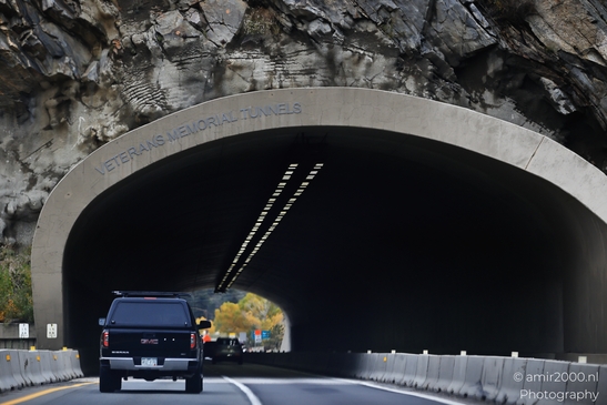 A GMC SUV is driving through the Veterans Memorial Tunnels in Colorado. - image from year 2025 #001