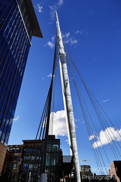 The Denver Millennium Bridge stands tall amidst a cityscape of skyscrapers and buildings under a - image from year 2025 #001