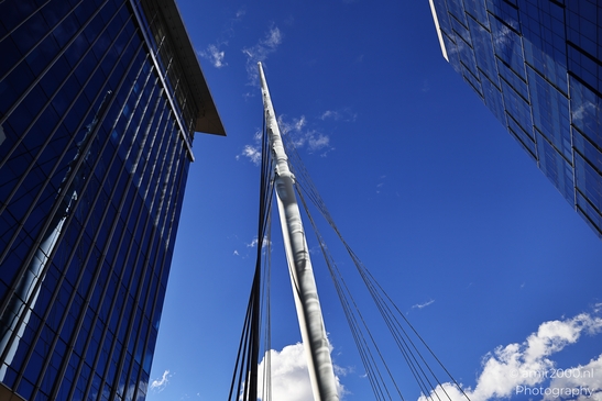 The Denver Millennium Bridge's towering mast and cable system against a clear blue sky in an - image from year 2025 #002