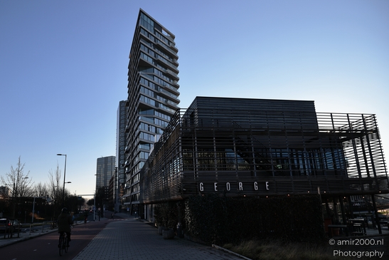 Against adjacent buildings, an architectural structure appears with pronounced facade texture in - image from year 2025 #002