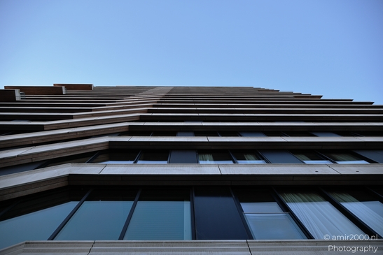 Against surrounding built forms, an architectural structure shows layered building structure in - image from year 2025 #008