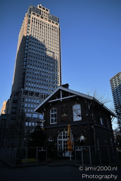 A skyscraper and a historic pub in Amsterdam. - image from year 2025 #004