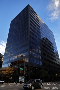 A modern office building with reflective windows in an urban setting. - image from year 2025 #001