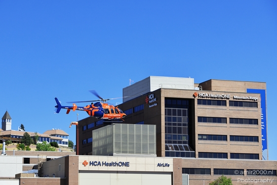 AirLife air ambulance helicopter N776AL Bel 407 Helicopter in flight above an urban landscape in image from year 2025 #1