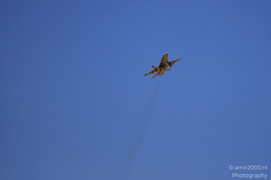 An F-16 Fighting Falcon in flight against a clear blue sky. - image from year 2025 #002