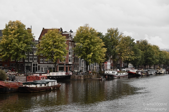 Peaceful Amsterdam canal with historic buildings and boats. in Amsterdam Netherlands. . - image from year 2025 #003