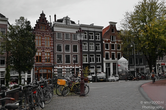 A picturesque view of Amsterdam's city center with traditional Dutch architecture and a bustling - image from year 2025 #007