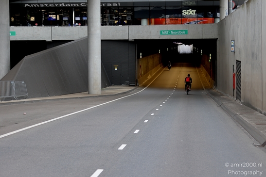 Cycling_on_De_Ruijterkade_under_Centraal_Station_during_Sail_2025_750_to_the_city_Amsterdam_Netherlands_Cityscape_Photography_Canon_EOS_R5_Mark_II_2025_001.JPG