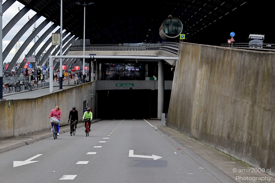 Cycling_on_De_Ruijterkade_under_Centraal_Station_during_Sail_2025_750_to_the_city_Amsterdam_Netherlands_Cityscape_Photography_Canon_EOS_R5_Mark_II_2025_004.JPG