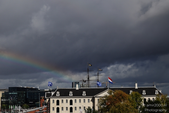 Rainbow in the sky over Amsterdam, Netherlands, with storm clouds looming above in Amsterdam - image from year 2025 #002