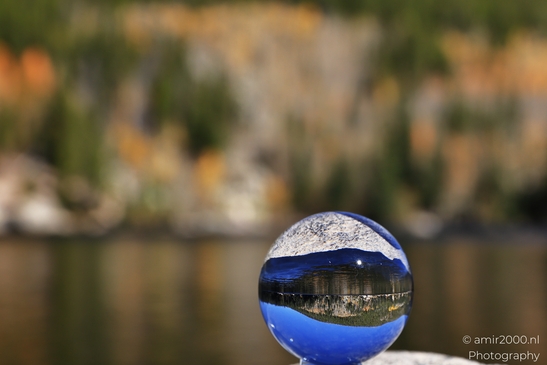 A glass ball reflects a lake in Rocky Mountain National Park, Colorado, with a mountain in the - image from year 2025 #008