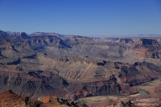From Lipan Point, Arizona USA, the Grand Canyon's vastness is captured with a clear blue sky as - image from year 2025 #009