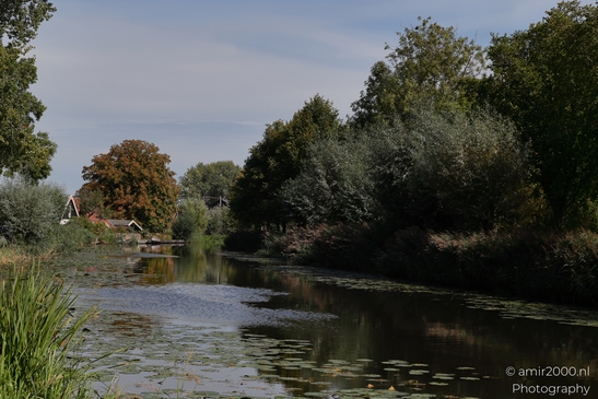 A serene river meanders through a lush landscape in the Netherlands in Nature Landscape - image from year 2025 #002
