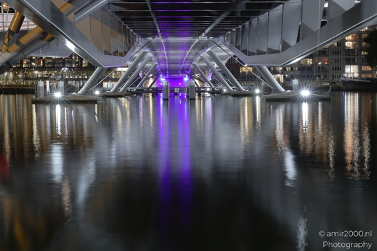 The Jan Schaeferbrug in Amsterdam, Netherlands, reflects the city lights on its calm waters at - image from year 2025 #003
