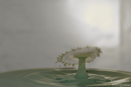 Water drops creative series: Dancing droplets collide in a vibrant yellow explosion of energy - image from year 2025 #001