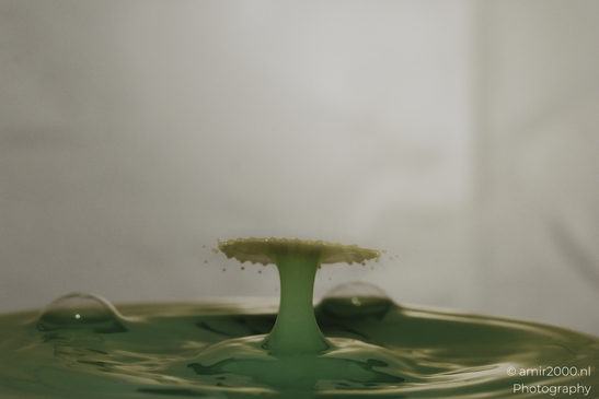 Water drops in a creative series, with yellow dancing droplets colliding in a dynamic display of - image from year 2025 #006