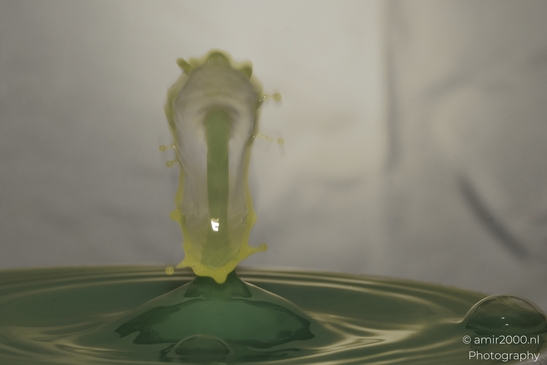 Water drops creatively collide in a vibrant yellow burst of energy in Water Drops Creative - image from year 2025 #021