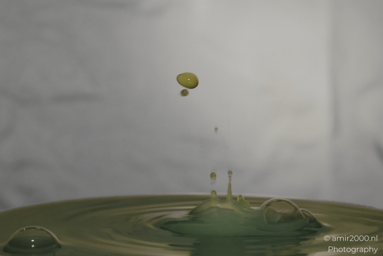 Water drops creatively collide in a series of yellow hues, capturing the essence of nature's - image from year 2025 #033