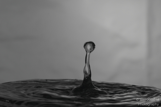 This image captures a single water droplet in motion, creating an artistic representation of a - image from year 2025 #035