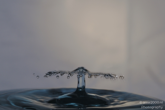 Water droplet splashing in mid-air, captured in a high-speed shot, part of a creative series - image from year 2025 #008
