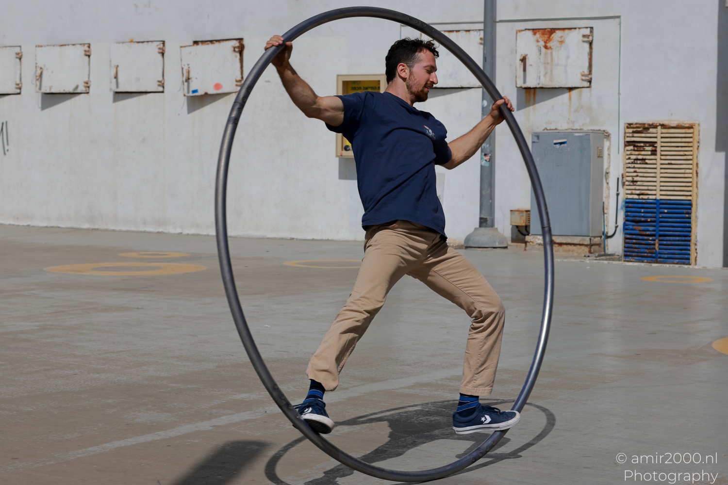Two Acrobats Share a Cyr Wheel in Tel Aviv-Jaffa