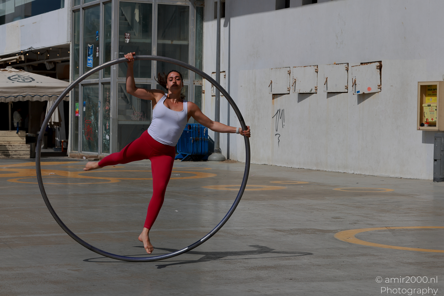 Male Cyr wheel acrobat standing inside the hoop in Tel Aviv-Jaffa