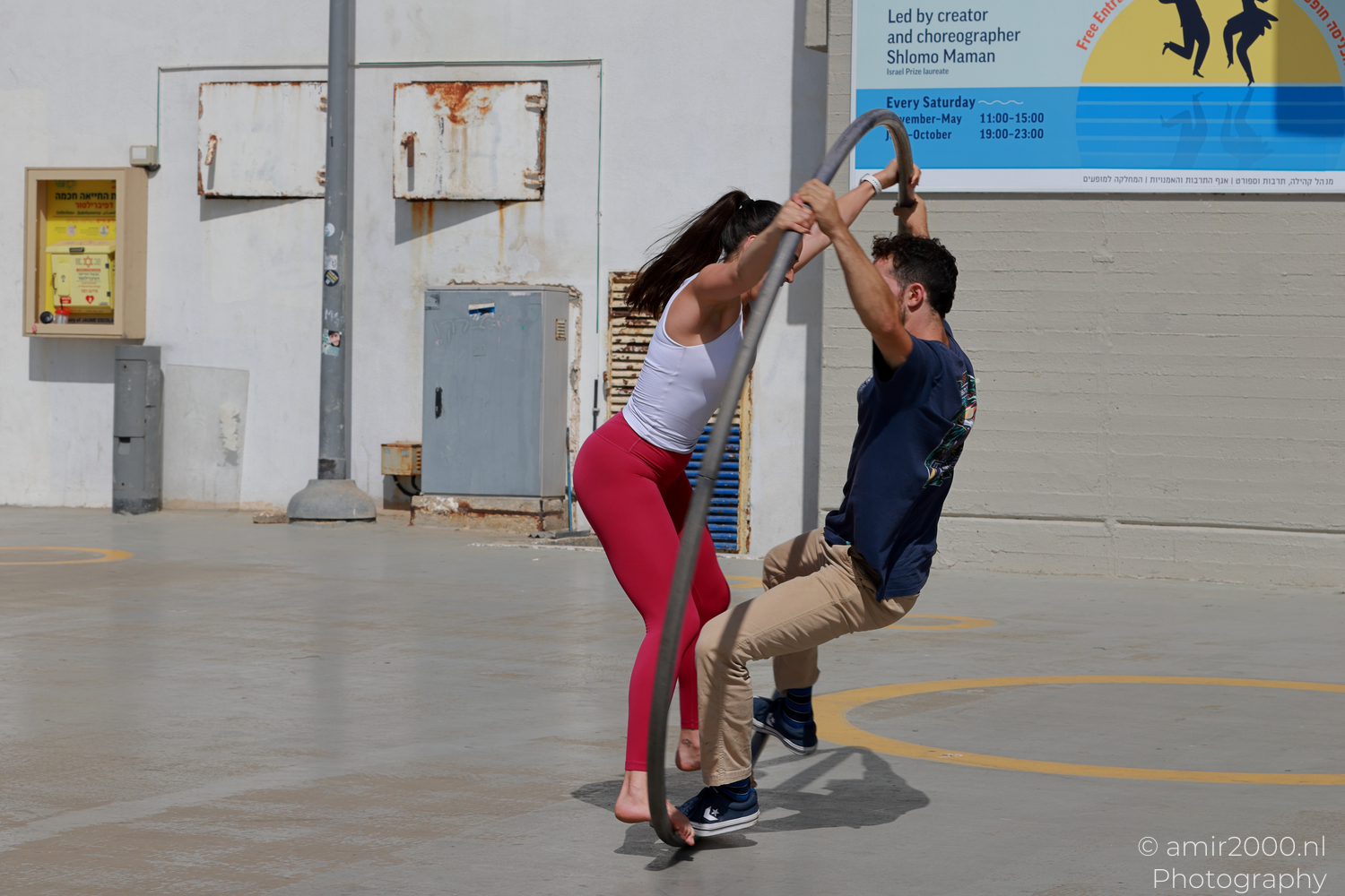 Two Cyr wheel acrobats sharing one hoop in Tel Aviv-Jaffa
