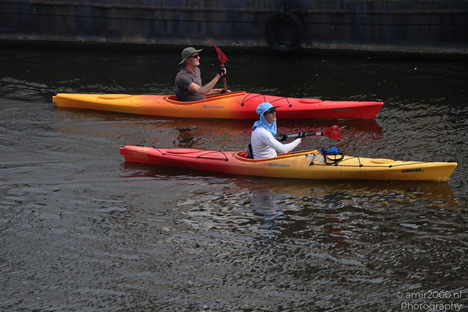 Canal water activity with kayaker on canal in Amsterdam, Netherlands.
