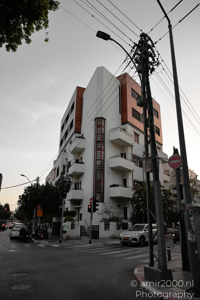 Renovated Bauhaus building rising above a street corner in Tel Aviv-Jaffa, Israel