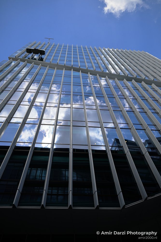 Vinoly Tower the reflection of a skyscraper in its own windows show a partly cloudy sky.