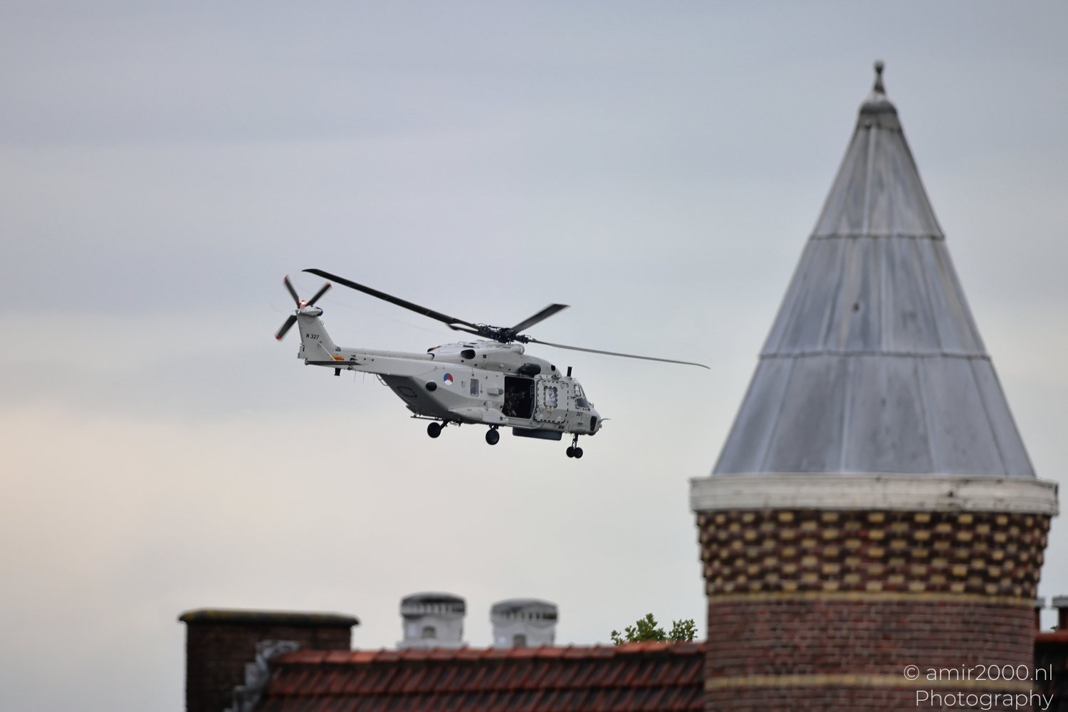 Royal Netherlands Navy NH90 NFH flying above rooftops in Amsterdam