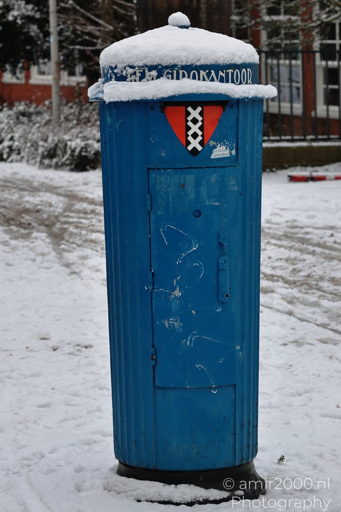 Snow covered vintage postbox in Amsterdam Netherlands.