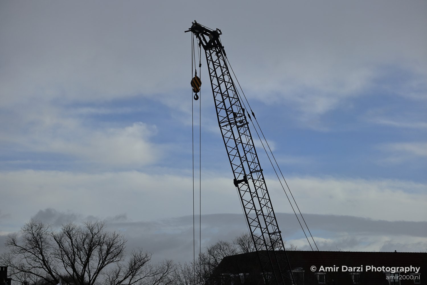 A tall metal structure in an urban setting during daytime.