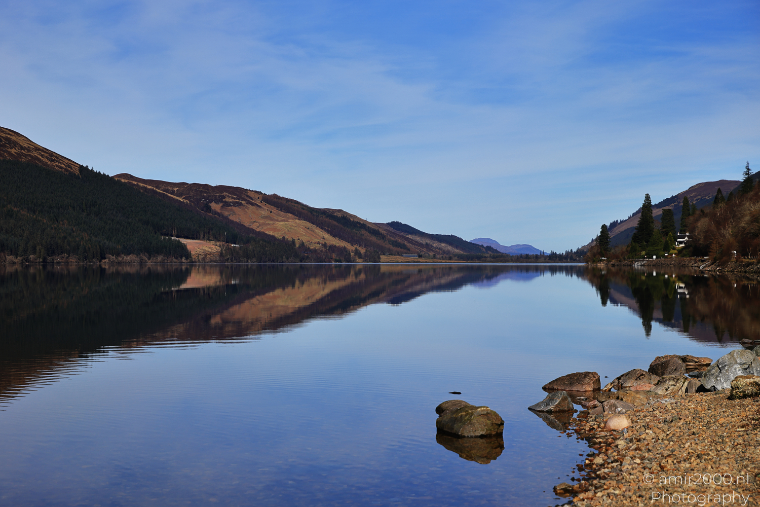 Loch Lochy shoreline with calm water reflecting Highland hills